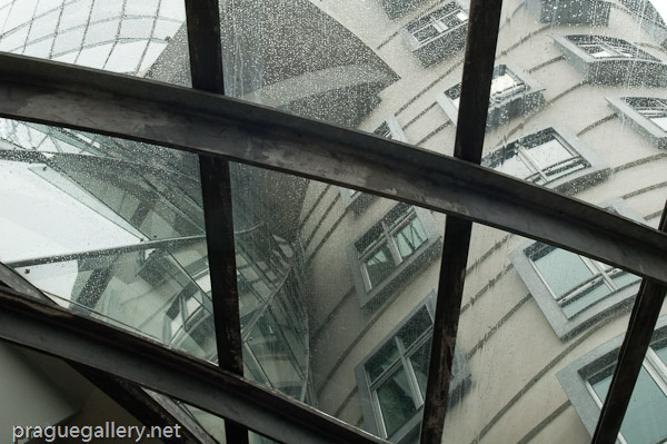 Detail of the Dancing House structure with raindrops.